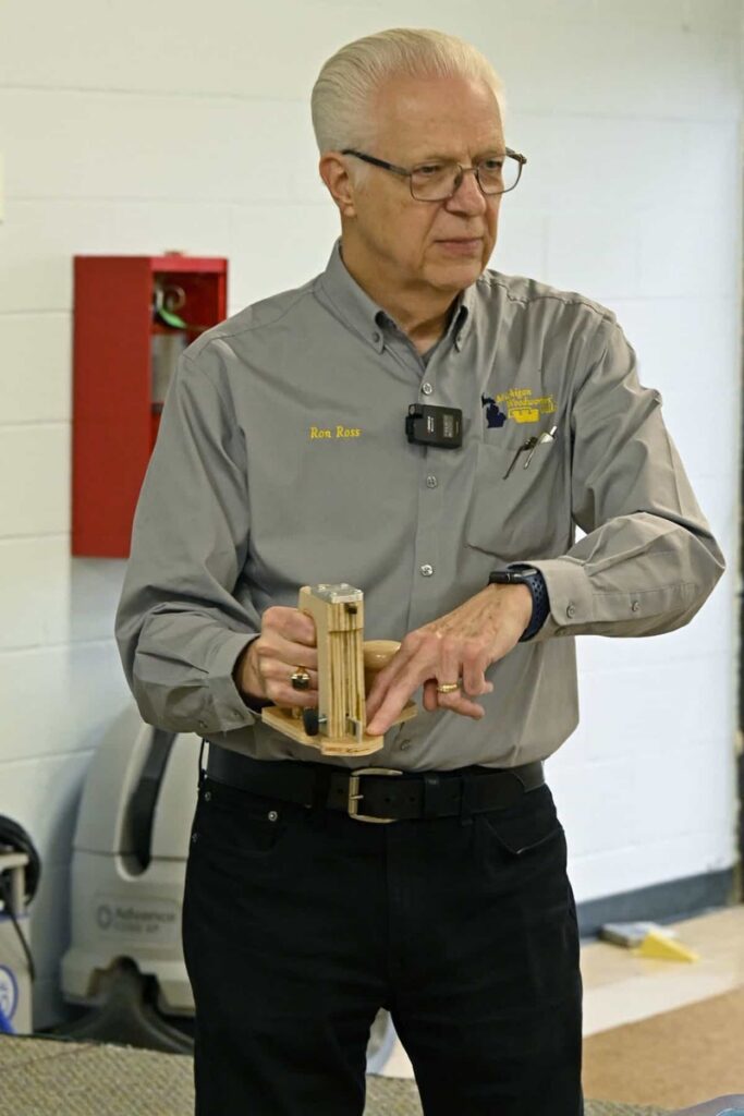 A member shows a small turned and joined wooden project.